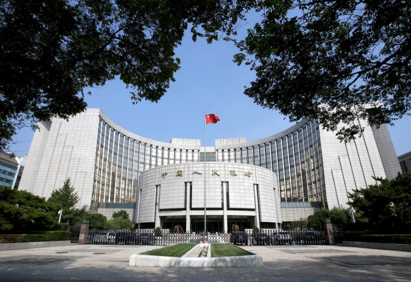 China leaves rates unchanged, weak yuan limits easing